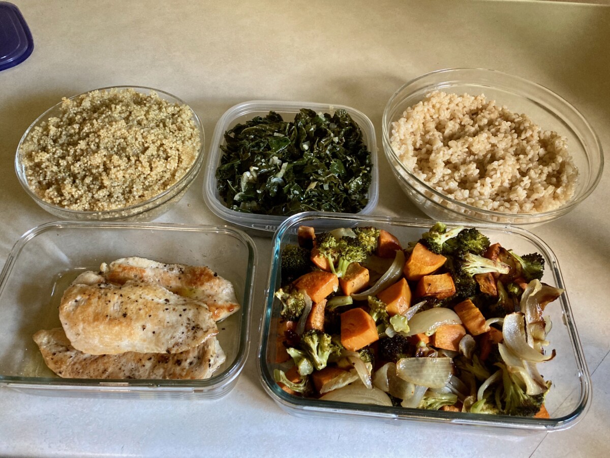 Containers of quinoa, rice, kale, chicken breasts, roasted vegetables